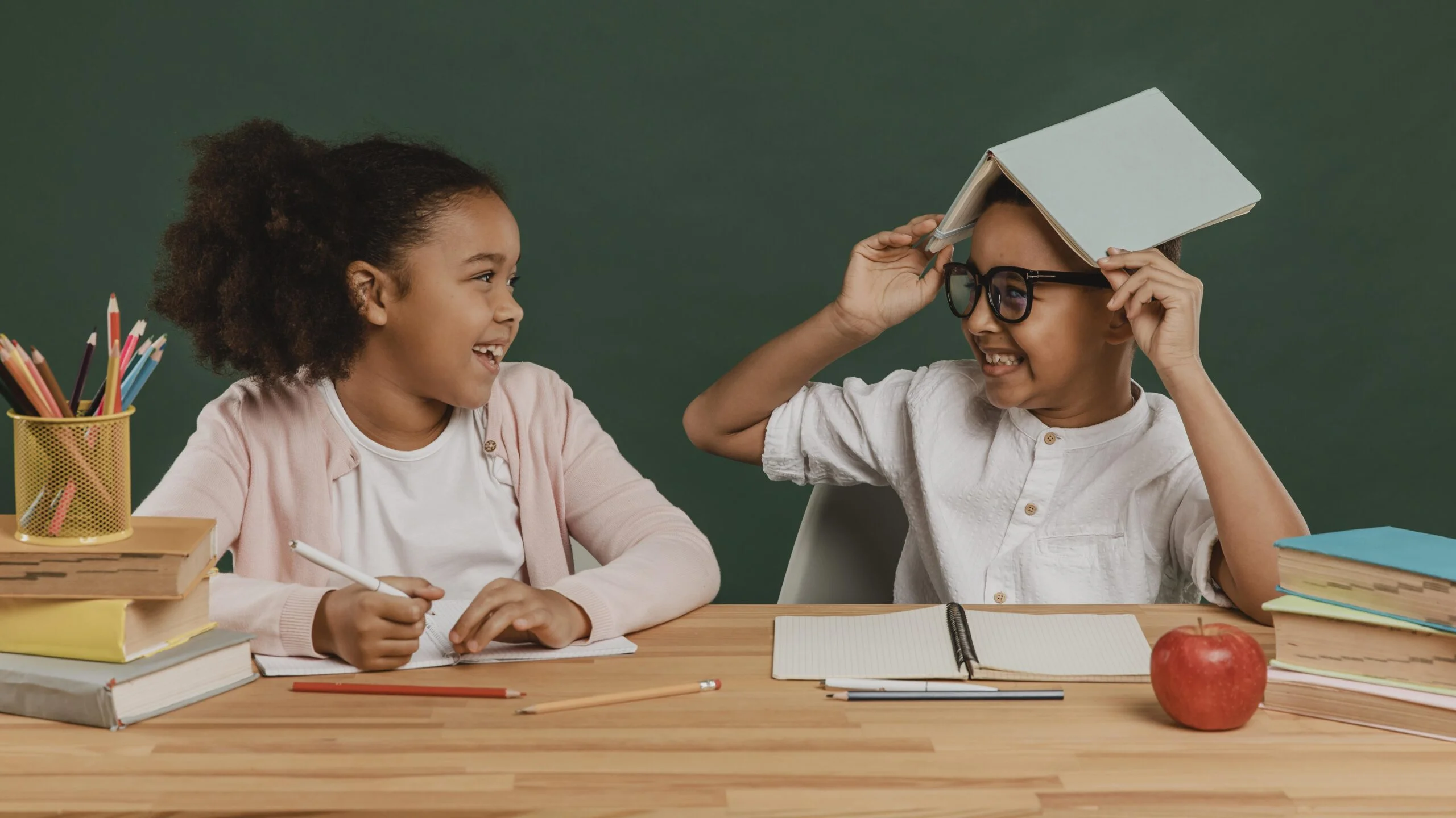 girl boy having fun with school supplies scaled